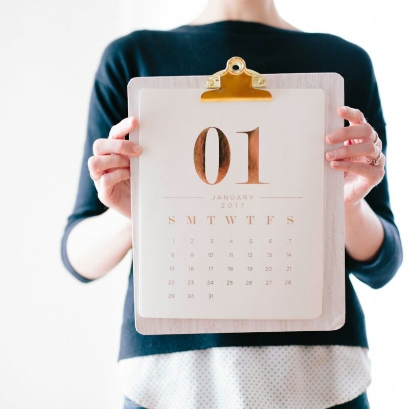 person holding calendar at January