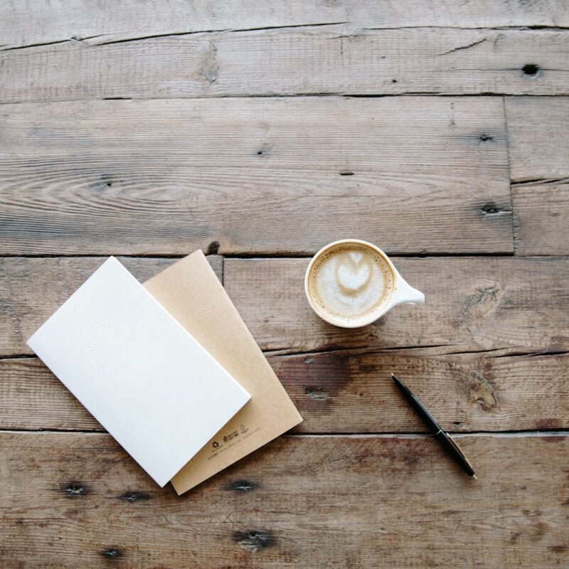 black twist pen near white teacup