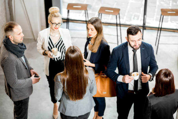 Business people having a conversation during the coffee break standing in the cafe