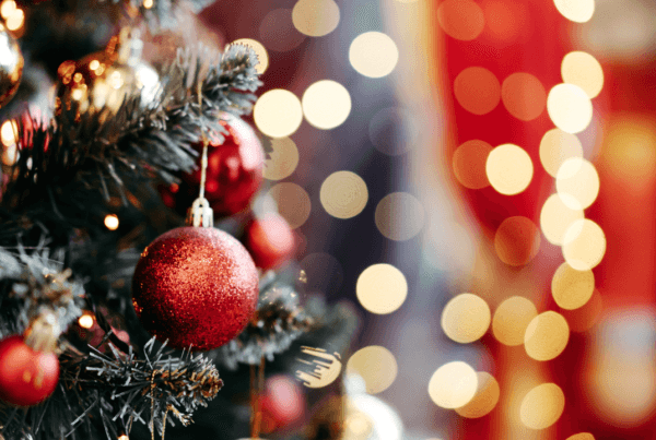 Close up of balls on Christmas tree. Bokeh garland in the background. New Year concept.