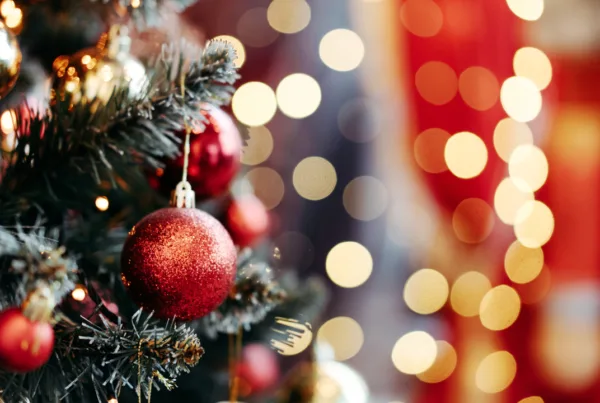 Close up of balls on Christmas tree. Bokeh garland in the background. New Year concept.