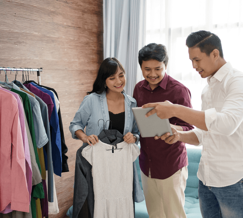 Portrait of a male businessman. Serving customers with tablets in the clothing shop