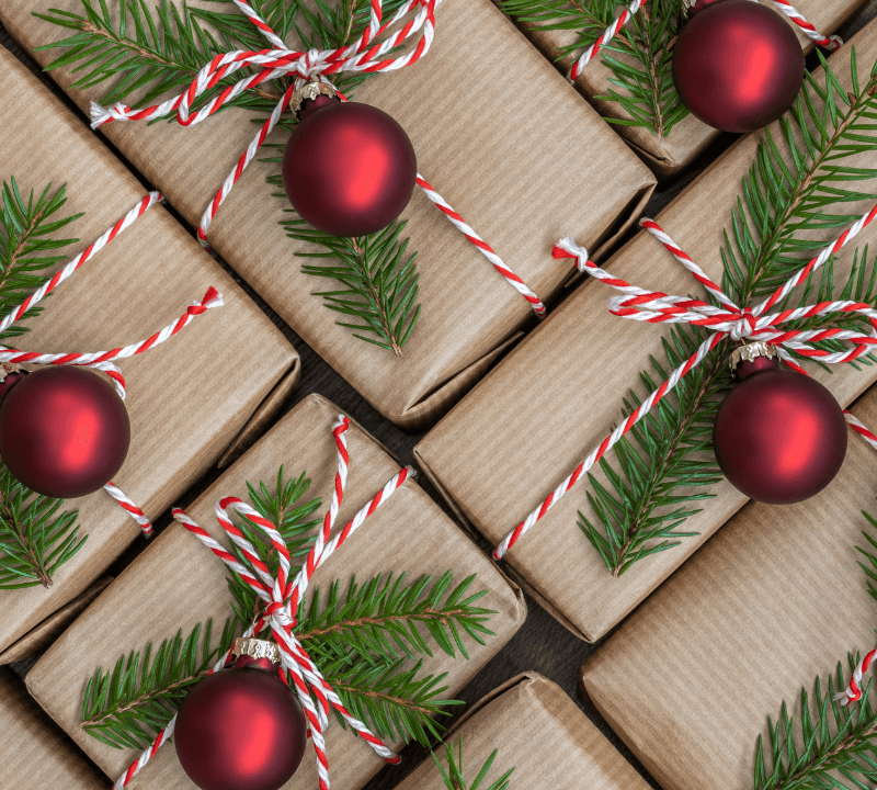 Christmas gifts. Gifts wrapped in brown paper. Christmas gift wrapping concept.