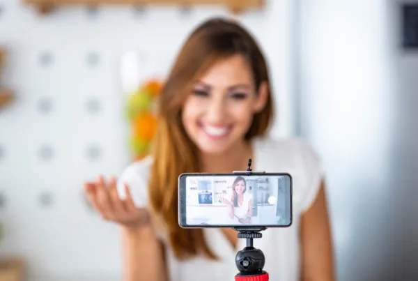 Young woman recording her vlog about health eating and nutritional supplements, close-up on a phone screen.