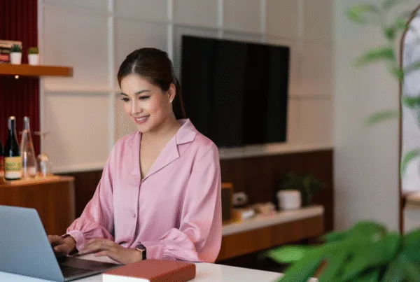 Female entrepreneur thinking strategy about new startup project and typing on laptop in home office.