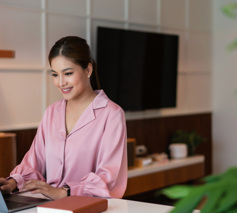 Female entrepreneur thinking strategy about new startup project and typing on laptop in home office.