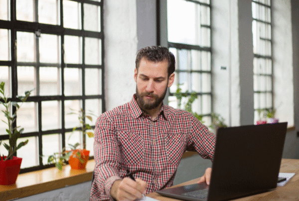 Handsome entrepreneur thinking about new business moves in his office.
