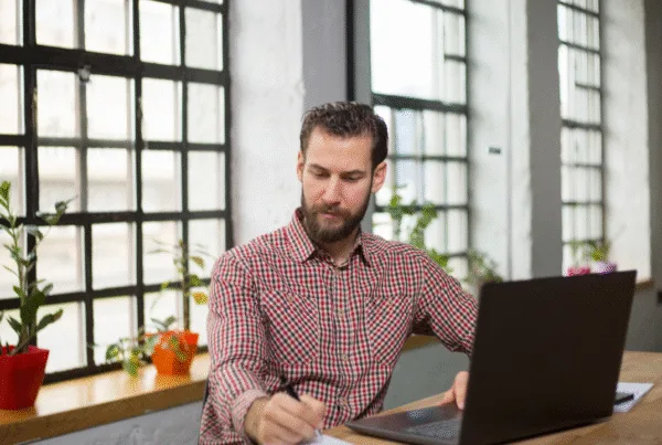 Handsome entrepreneur thinking about new business moves in his office.