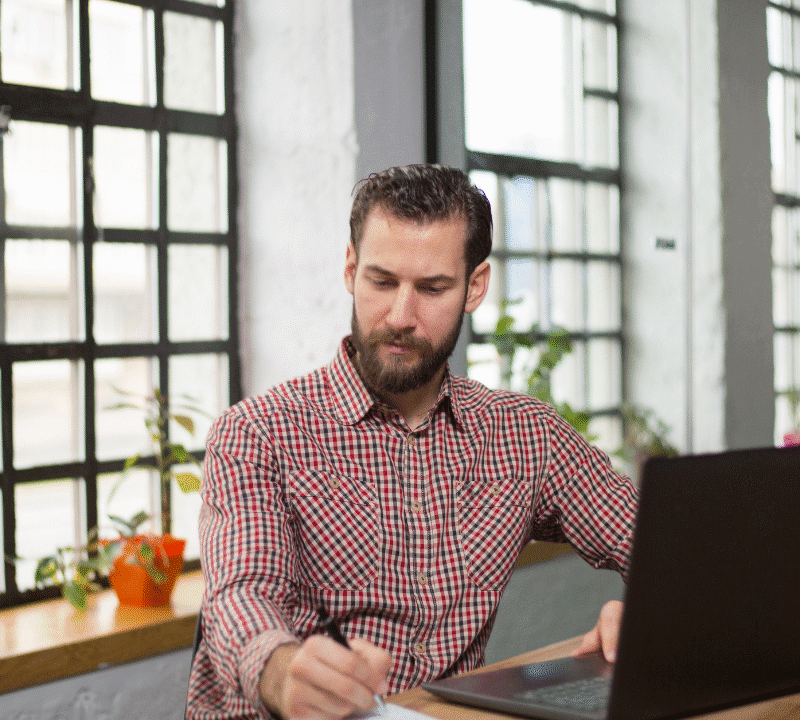 Handsome entrepreneur thinking about new business moves in his office.