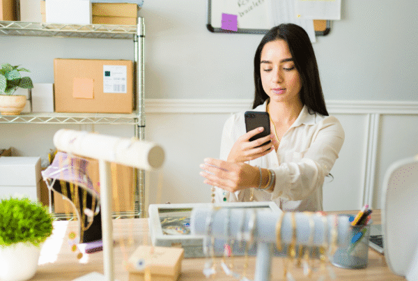 Beautiful young woman posting pictures on the internet of the jewelry and selling online.