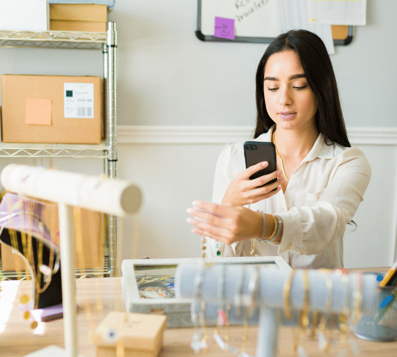Beautiful young woman posting pictures on the internet of the jewelry and selling online.