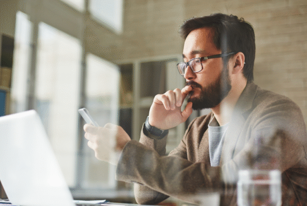 Modern office worker writing sms.