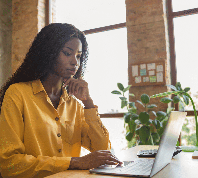 profile side photo of afro american woman work office laptop serious executive workspace indoors in office.