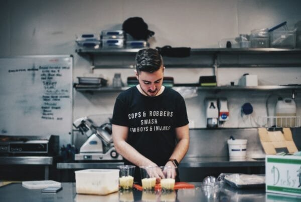 man in black shirt beside kitchen table