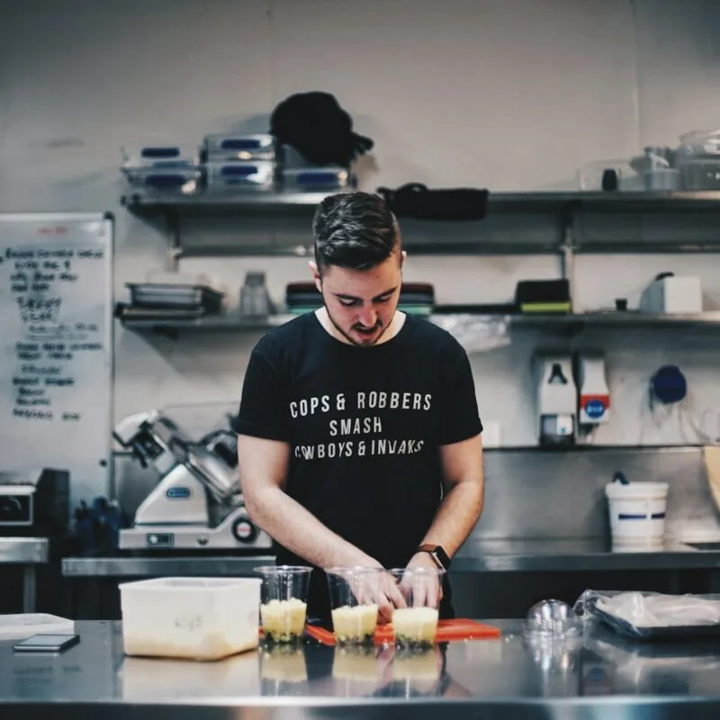 man in black shirt beside kitchen table