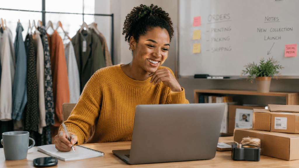 A small business owner works from a home office, assisting customers online while managing orders, showcasing a seamless and customer-focused business experience.