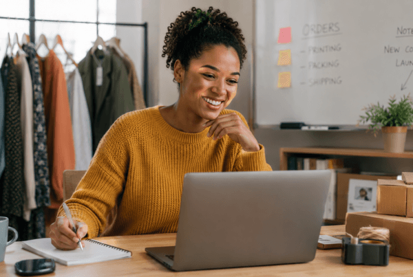 A small business owner works from a home office, assisting customers online while managing orders, showcasing a seamless and customer-focused business experience.