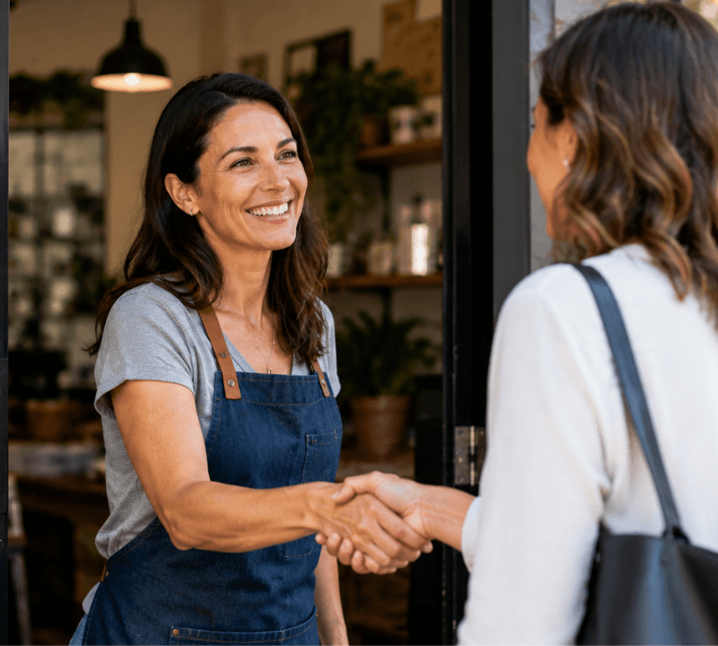 Business owner welcoming a customer to illustrate a positive first impression.