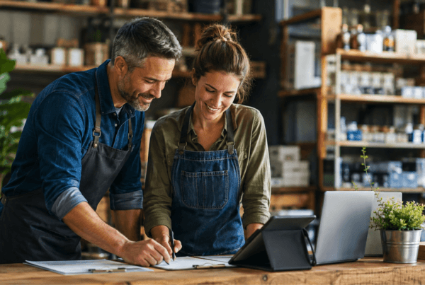 Business owner and employee reviewing workflows to improve business processes.
